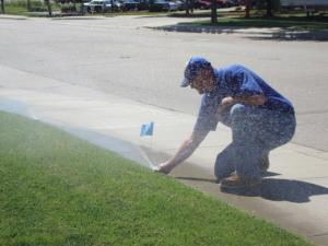 one of our Cutler Bay sprinkler repair specialists is adjusting a sprinkler head