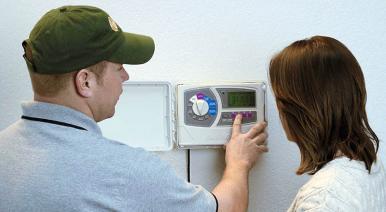 Homestead FL irrigation contractor shows a homeowner how to set her Rain Bird sprinkler timer