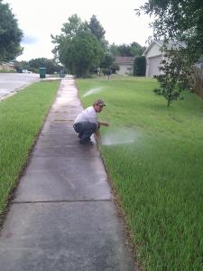 a Redland sprinkler repair specialist is checking the system